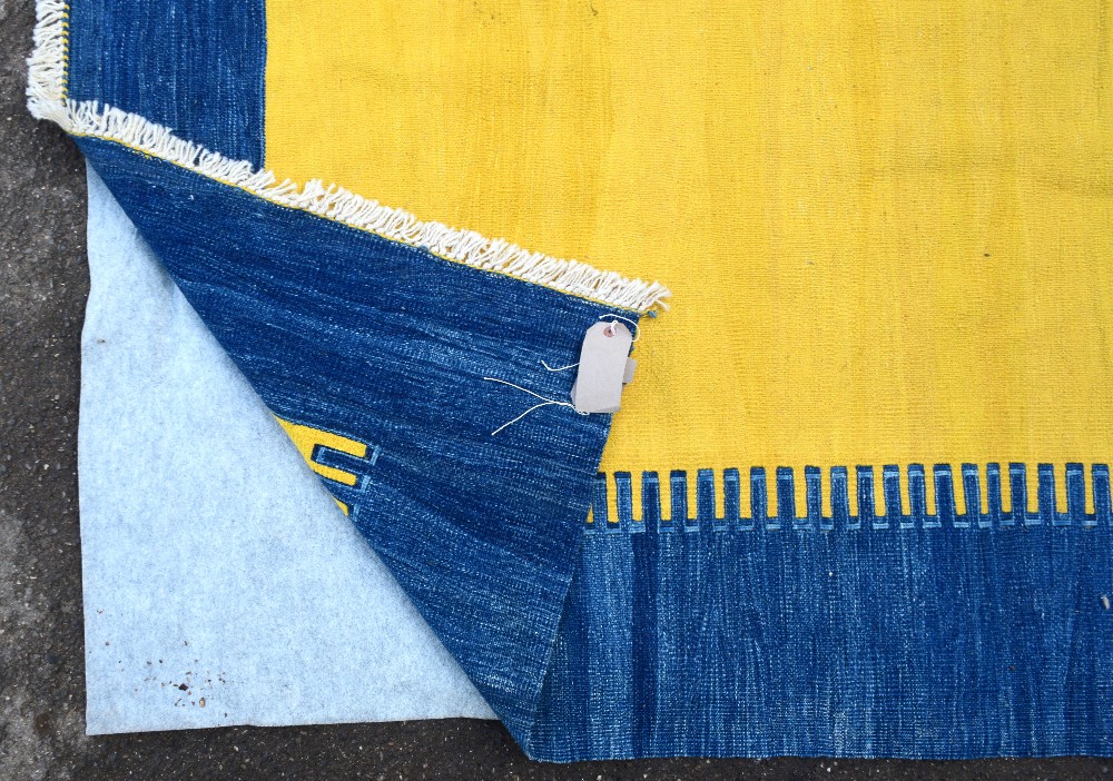 Modern yellow ground rug with a blue border,. . - Image 3 of 3