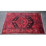 Persian style red ground rug, with central medallion and multiple borders, 237cm x 139cm,. .