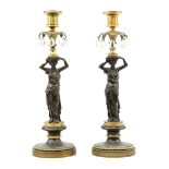 Pair of French bronze and gilt metal classical figure candlesticks with hanging drops on round