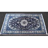 Persian style wool rug, cream ground with concentric blue medallions, 214 x 125 cm. .