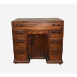 19th century mahogany knee hole desk of seven drawer configuration and a central cupboard,