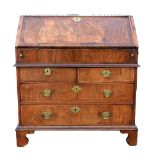 George II walnut bureau, fall flap enclosing well, pigeon holes, cupboard and drawers, over two