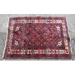 Persian red ground rug with repeating small floral forms, and multiple borders, 150cm x 103cm,. .