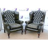 Set of three leather button back wing arm chairs raised on mahogany cabriole legs. .