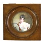 19th century circular portrait miniature depicting a young woman in a white dress leaning on a