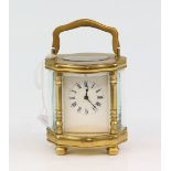 Brass and glass serpentine miniature carriage clock with lever movement 12cm. .