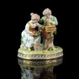 Dresden porcelain figural group of a boy and a girl holding a garland of flowers, with bird