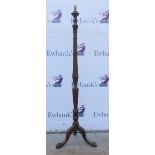 Carved mahogany standard lamp on tripod base and claw feet. 150cm . .