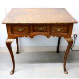 Early 18th century walnut and crossbanded lowboy with three drawers, shaped apron on slender