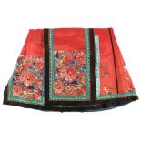A Tomato-Red ground, Chinese textile skirt; decorated with floral and Natural History designs.