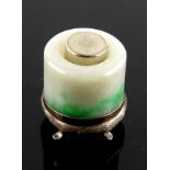 A mottled jadeite, or other stone, archer's ring mounted in white metal as a gentleman's