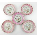 A set of five famille rose dishes; each one decorated with a central floral design surrounded by a