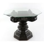 An Indian, sectional wood, side table with flaming mandala and floral designs; the octagonal glass