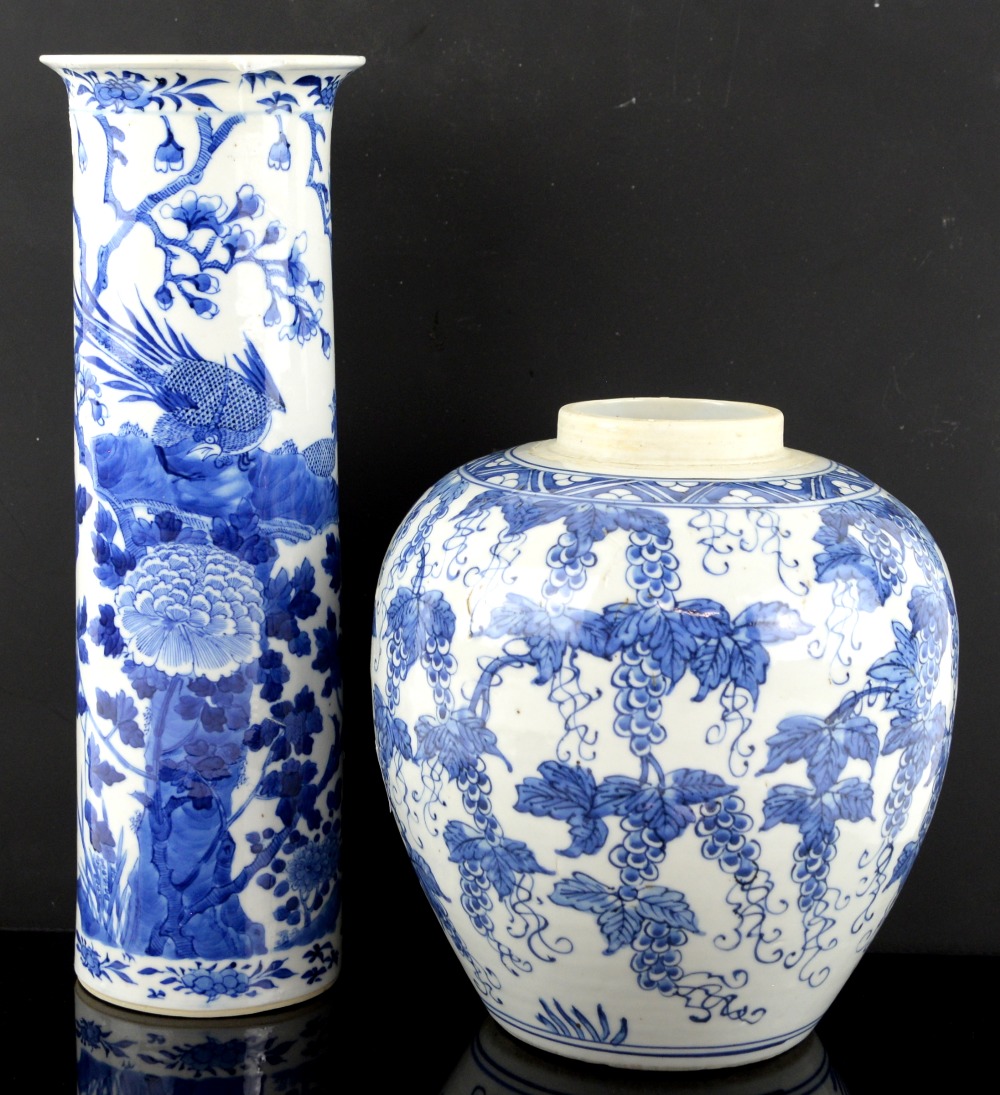 A blue and white vase with unglazed base, decorated with fruiting vine, 24 cm high; together with