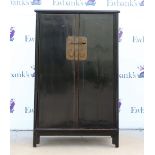 A Chinese black lacquer cabinet of typical trapezoid form with metal fittings, 82 x 42 x 135 cm,