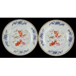 A pair of Chinese Export plates; each one decorated en-grisaille and in famille rose with five