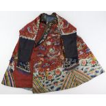 A red-brown ground, Chinese textile tunic, decorated with a variety of symbols and flowers,