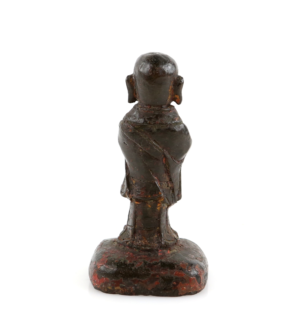 A small Chinese metal figure of a standing Luohan, standing with both hands clasped together in - Image 2 of 3