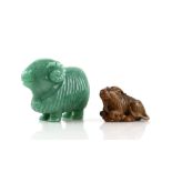A wood netsuke, carved as a recumbent goat with its torso and head curved slightly towards the left;