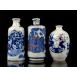 Three Chinese snuff bottles: one in blue and white decorated with a group of boys beside a tree,