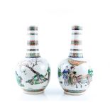 An elegant pair of famille verte vases; each one with oviform body and cylindrical neck, decorated