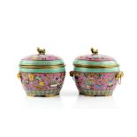 A pair of Chinese cloisonne enamel vessels; each one with domed cover and liner, decorated on the