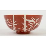 An orange-red ground bowl, decorated with bamboo; the base with underglaze blue six-character mark