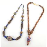 Two Tibetan, or other Asian, necklaces; each one strung with a variety of archaistic, dZi style