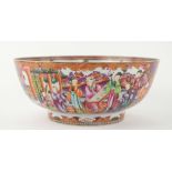 An elegant famille rose punch bowl, decorated with panels depicting Manchu/Chinese families; 33.5 cm