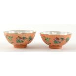 A pair of coral ground, famille rose bowls, each one decorated with insects and floral designs, 9.