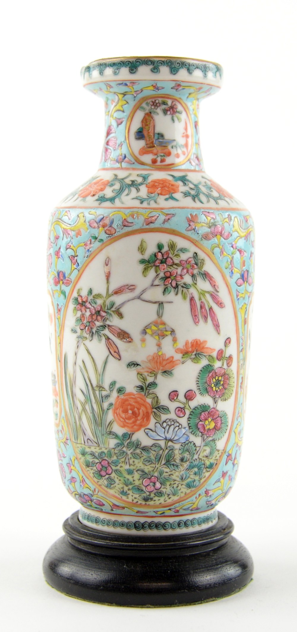 A small famille rose vase of rouleau form, decorated with oval panels of floral designs; the base