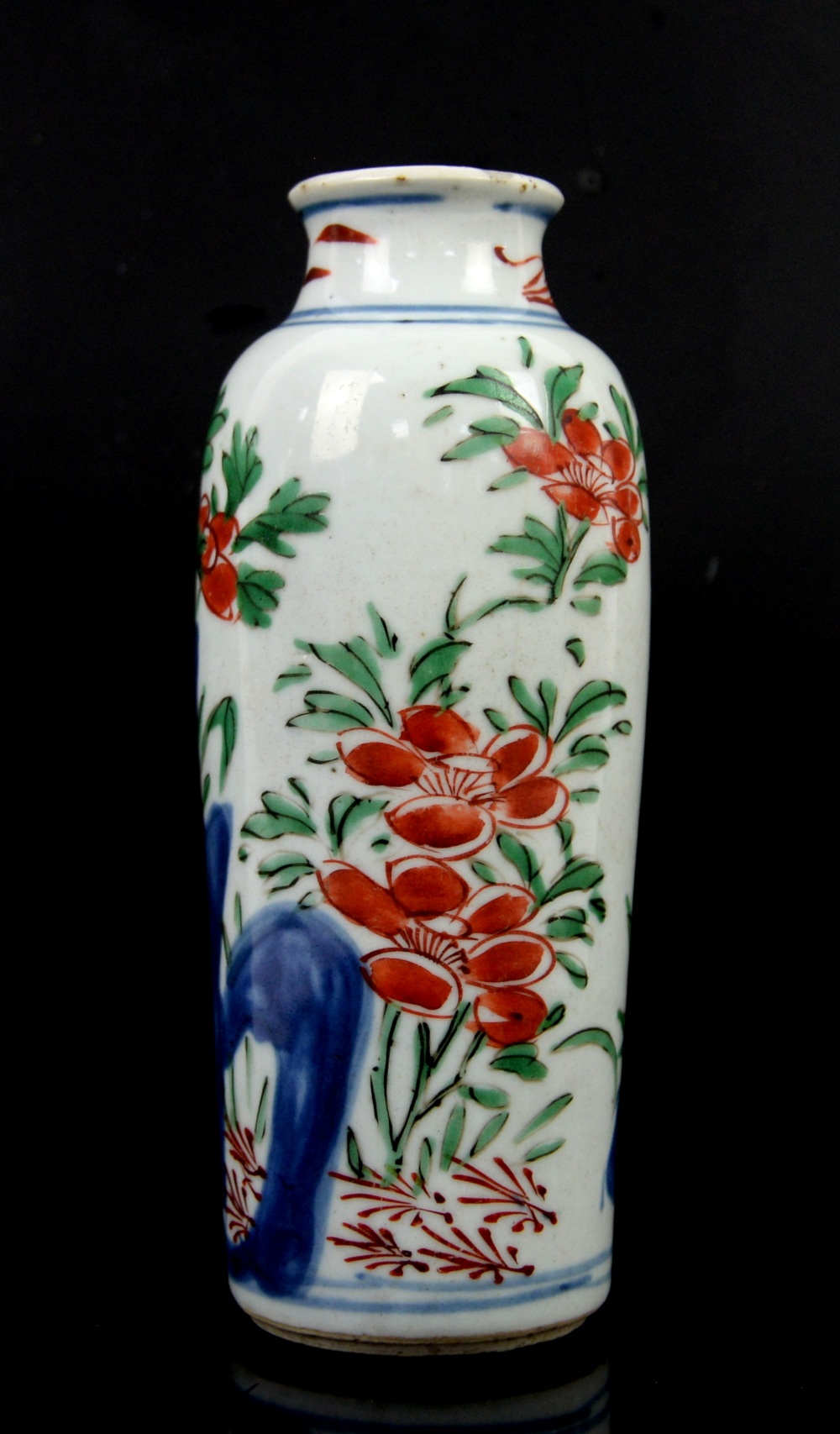 A small Transitional sleeve vase with unglazed base; decorated with orange-red flowers, green