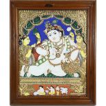 A Thanjavur [Tanjore] painting of the Young Lord Krishna, holding on carefully to the large butter
