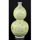 A lime-green ground double gourd vase with scrolling and floral designs; the base with Tongzhi six-