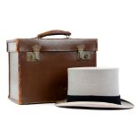 A Christies grey felt top hat, in original leather case 57.5cm. Some light staining /wear marks to