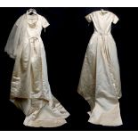 A Normal Hartnell cream satin wedding dress with train, lined and with part net underskirt, believed