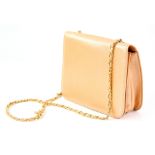 Bruno Magli peach coloured handbag with gold chain shoulder handle with dust bag and a red holdall.