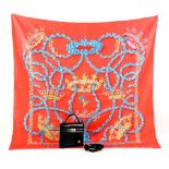 Hermes silk scarf by H 'Origny with floral bird and ribbon print on a coral ground, unboxed and a