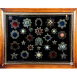 Collection of thirty embroidered motifs, 19th / 20th Century. Possibly Indian. With border, framed