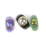 Three gemstone rings, one set with a round cut peridot, another amethyst and a checkerboard cut