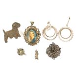 A group of costume jewellery, a silver terrier brooch, a pair of earrings, silver bear charm,