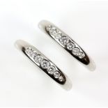 Jon Dibben two matching diamond rings, each set with seven graduated round brilliant cut diamonds,