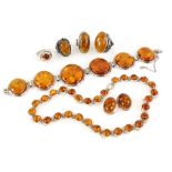 A group of silver set amber items, including bracelet set with round cabochon cut stones,