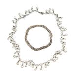 A group of costume jewellery including a white paste fringe necklace, a silver amethyst set