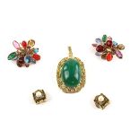 Gold pendant, centrally set with oval green paste stone, mounted in scrolling border, stamped 14 ct,