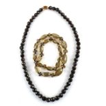Necklace of faceted garnet beads to a gold clasp, stamped 9 ct, length 48 cm, and another of