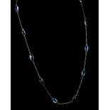Blue topaz necklace; twelve marquise faceted blue topaz, spectacle set and connected with chain