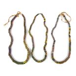 Three African trade bead necklaces, rolled millefiore glass in venetian style 19th century and