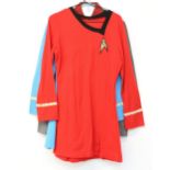 Two replica Star Trek female officers tops, one red and one blue, and a unknown sci fi top with