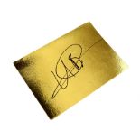 Usain Bolt - Jamaican Sprinter, a signed gold card, 15 x 21 cm. .